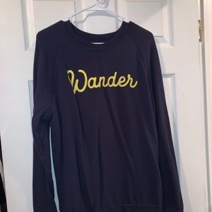 Medium navy blue wander crew neck. Yellow Logo